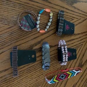 7 bracelets. 1 cuff, 1 pull cord. Rest are stretchy. Paparazzi $2.75 a piece.